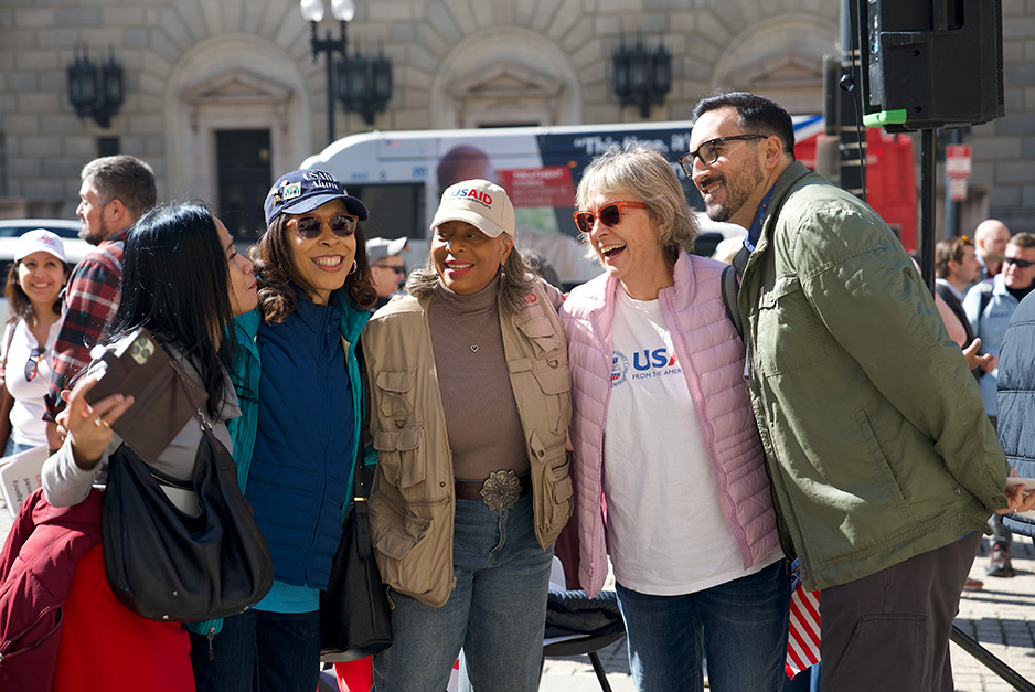 people smiling and wearing USAID apparel